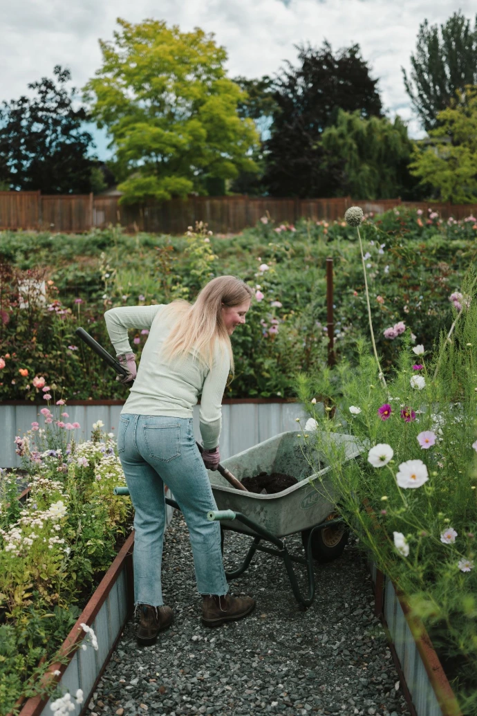 Farmer tending to lush green plant rows in a sustainable field